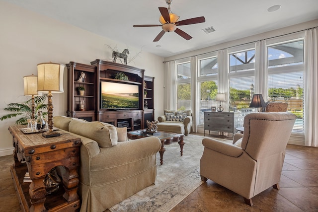 2850 Woodland Glen Ln, Conroe, TX 77385 - living area with ceiling fan and dark tile patterned flooring