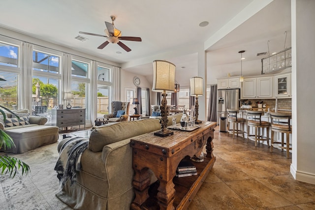 2850 Woodland Glen Ln, Conroe, TX 77385 - living area featuring ceiling fan and dark stone finish flooring