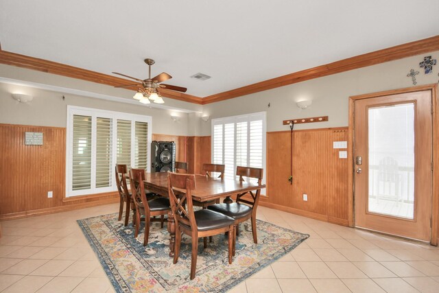 13134 Gulf Beach Dr, Freeport, TX 77541 - dining area with a wainscoted wall, ceiling fan, wooden walls, light tile patterned flooring, and ornamental molding