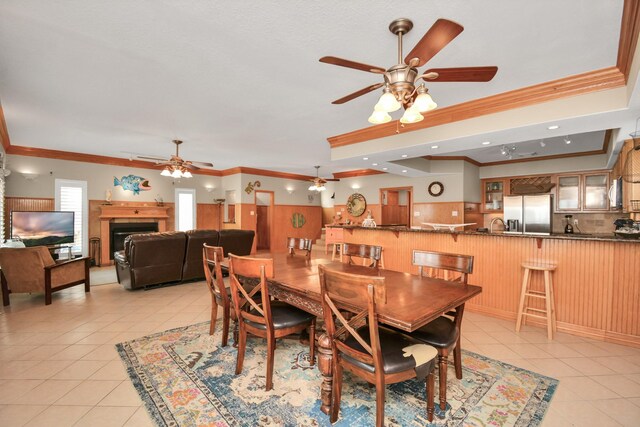 13134 Gulf Beach Dr, Freeport, TX 77541 - dining room with ceiling fan, ornamental molding, light tile patterned flooring, recessed lighting, and a fireplace