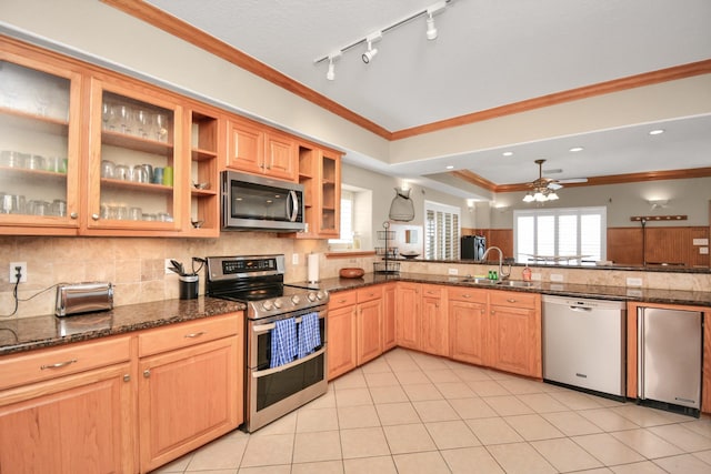13134 Gulf Beach Dr, Freeport, TX 77541 - kitchen featuring stainless steel appliances, a sink, ceiling fan, decorative backsplash, and ornamental molding
