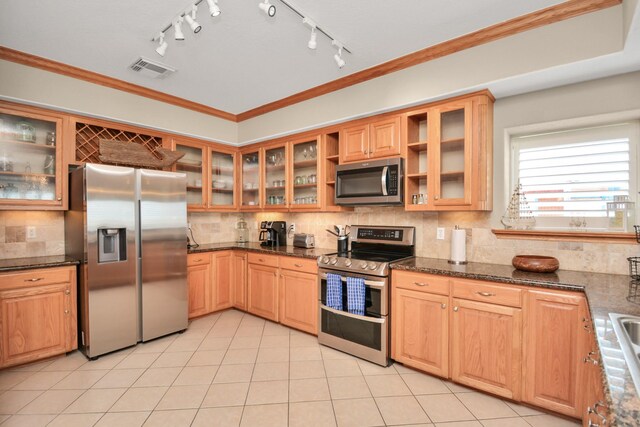 13134 Gulf Beach Dr, Freeport, TX 77541 - kitchen featuring stainless steel appliances, tasteful backsplash, light tile patterned flooring, dark stone countertops, and glass insert cabinets