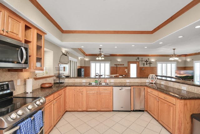 13134 Gulf Beach Dr, Freeport, TX 77541 - kitchen with stainless steel appliances, a ceiling fan, a sink, backsplash, and ornamental molding