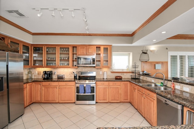 13134 Gulf Beach Dr, Freeport, TX 77541 - kitchen featuring stainless steel appliances, a sink, ornamental molding, backsplash, and light tile patterned floors