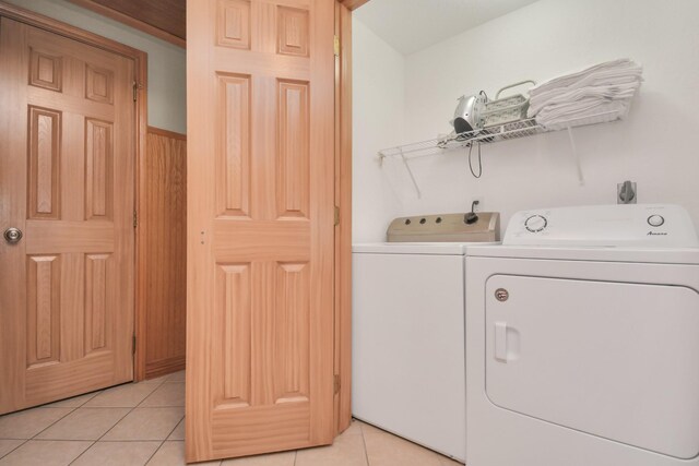 13134 Gulf Beach Dr, Freeport, TX 77541 - washroom featuring washing machine and dryer and light tile patterned flooring