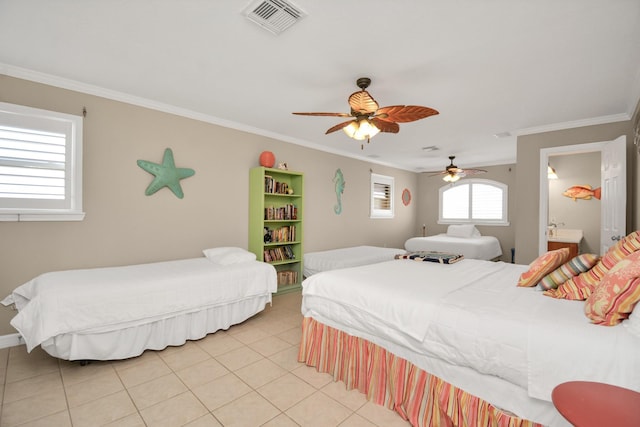 13134 Gulf Beach Dr, Freeport, TX 77541 - bedroom with crown molding, light tile patterned flooring, ceiling fan, ensuite bath, and baseboards