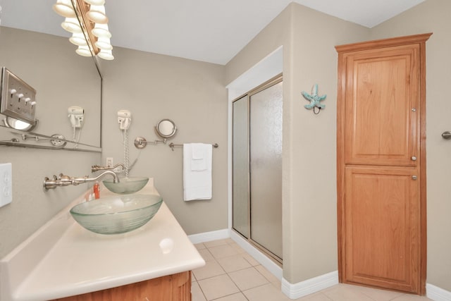13134 Gulf Beach Dr, Freeport, TX 77541 - bathroom with a shower stall, double vanity, tile patterned floors, and baseboards