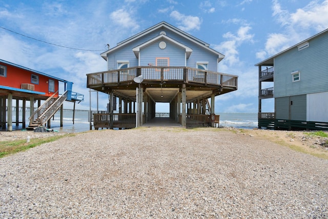 13134 Gulf Beach Dr, Freeport, TX 77541 - beach home featuring driveway, stairs, and a deck with water view