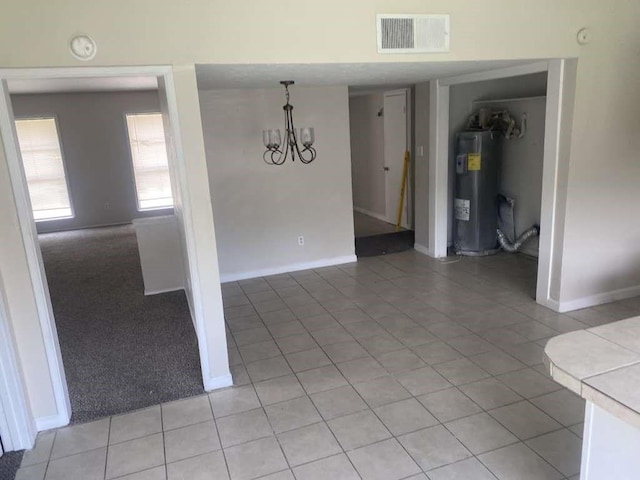 unfurnished dining area featuring water heater, baseboards, a chandelier, and light tile patterned flooring