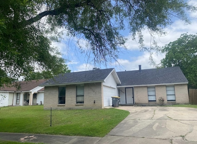 single story home featuring brick siding, a front yard, concrete driveway, a garage, and roof with shingles