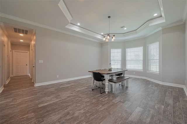 3331 Bridgette Ln, Baytown, TX 77523 - dining area with a tray ceiling, dark wood-style floors, a chandelier, baseboards, and crown molding