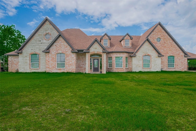 3331 Bridgette Ln, Baytown, TX 77523 - french country home with a front yard, brick siding, stone siding, and a shingled roof