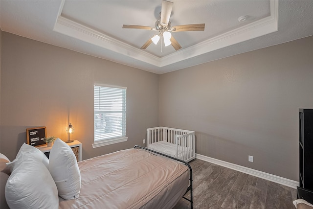 3331 Bridgette Ln, Baytown, TX 77523 - bedroom featuring a tray ceiling, crown molding, wood finished floors, baseboards, and ceiling fan