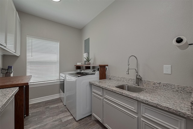 3331 Bridgette Ln, Baytown, TX 77523 - washroom featuring independent washer and dryer, cabinet space, dark wood-style flooring, and baseboards