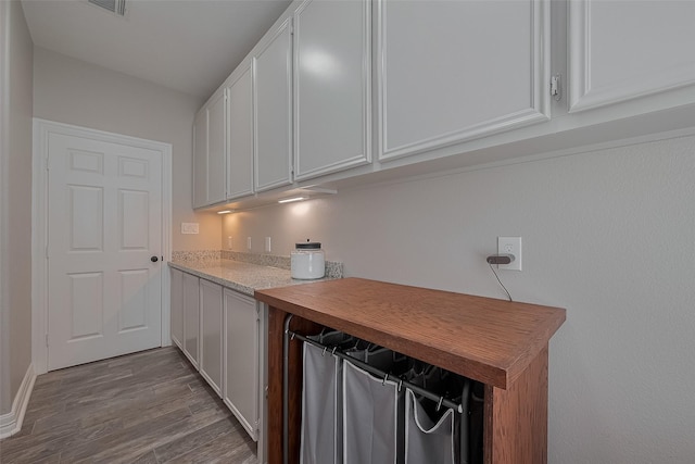 3331 Bridgette Ln, Baytown, TX 77523 - laundry room with wood finished floors and baseboards