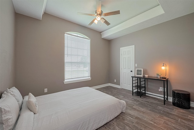 3331 Bridgette Ln, Baytown, TX 77523 - bedroom with dark wood-type flooring, baseboards, and a ceiling fan