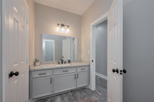 3331 Bridgette Ln, Baytown, TX 77523 - bathroom with vanity, wood finished floors, and baseboards