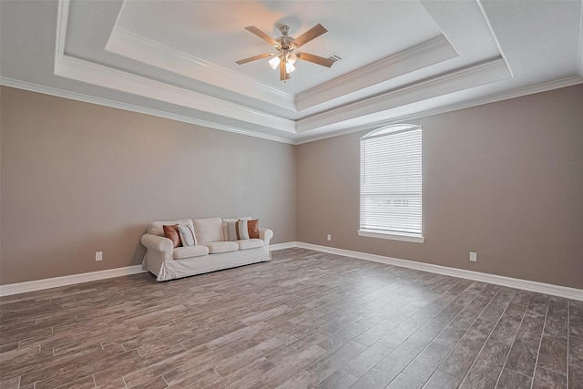 3331 Bridgette Ln, Baytown, TX 77523 - unfurnished room featuring a tray ceiling, a ceiling fan, dark wood-style flooring, crown molding, and baseboards