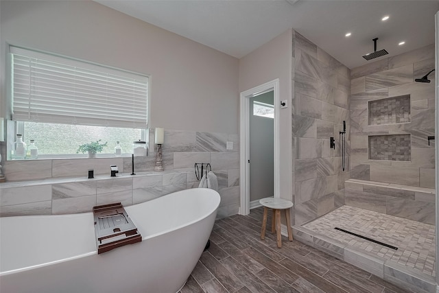 3331 Bridgette Ln, Baytown, TX 77523 - bathroom featuring a soaking tub, a tile shower, recessed lighting, and tile walls