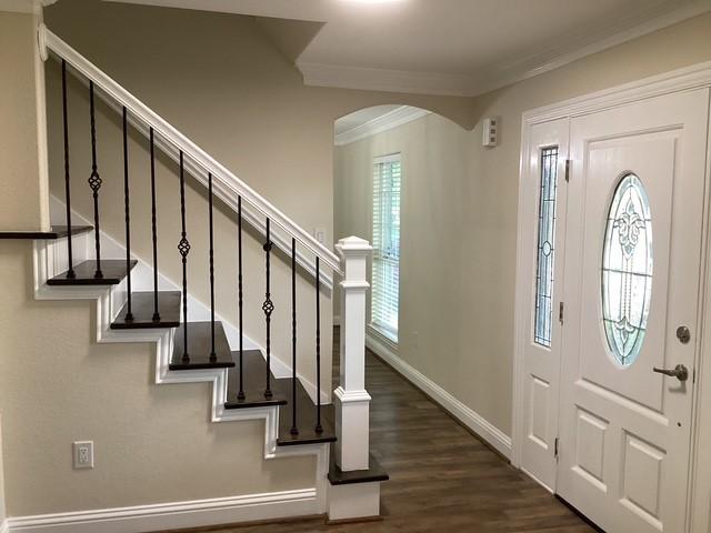 15311 Empanada Dr, Houston, TX 77083 - entrance foyer featuring ornamental molding, dark wood-type flooring, baseboards, stairs, and arched walkways
