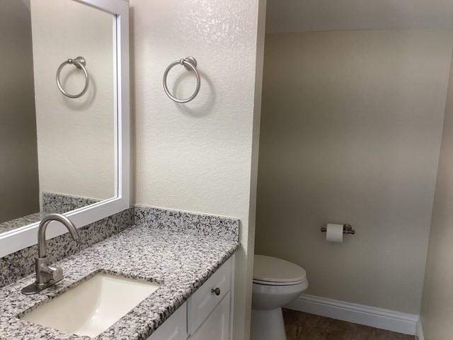 15311 Empanada Dr, Houston, TX 77083 - bathroom with vanity, toilet, and baseboards