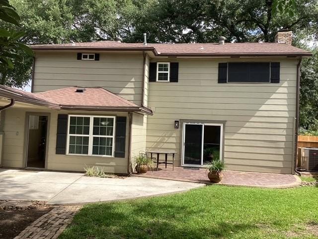 15311 Empanada Dr, Houston, TX 77083 - back of house featuring a patio, a chimney, cooling unit, a yard, and roof with shingles