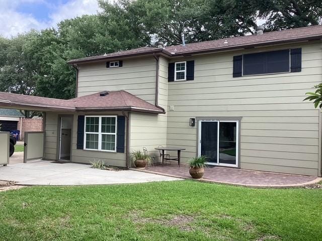15311 Empanada Dr, Houston, TX 77083 - rear view of property with a patio area and a lawn