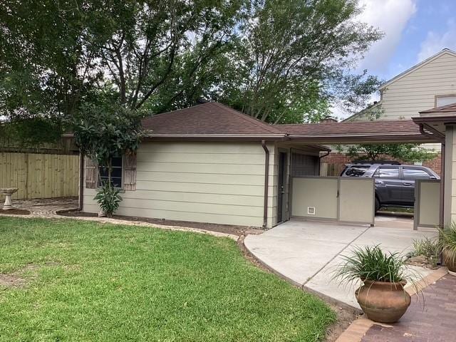 15311 Empanada Dr, Houston, TX 77083 - view of side of home featuring a shingled roof and a patio
