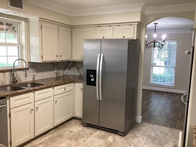 15311 Empanada Dr, Houston, TX 77083 - kitchen featuring stainless steel appliances, a sink, plenty of natural light, arched walkways, and crown molding