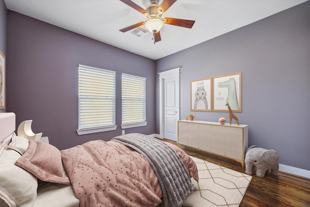 814 Nicholson St, Houston, TX 77007 - bedroom with baseboards, wood finished floors, and ceiling fan