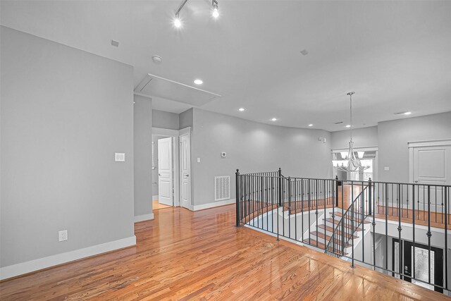 814 Nicholson St, Houston, TX 77007 - unfurnished room with attic access, light wood-style floors, a chandelier, recessed lighting, and baseboards