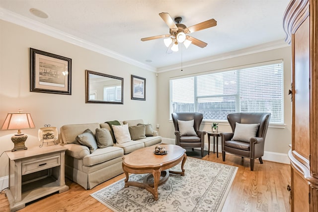 living area with ceiling fan, light wood-type flooring, ornamental molding, and baseboards