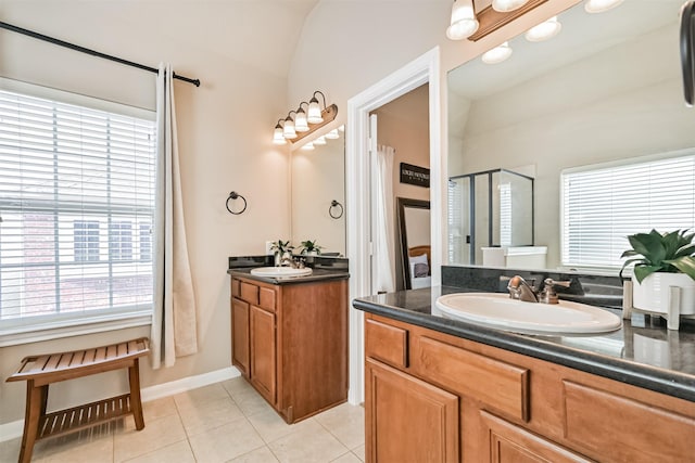 full bathroom with a shower stall, tile patterned floors, two vanities, and lofted ceiling