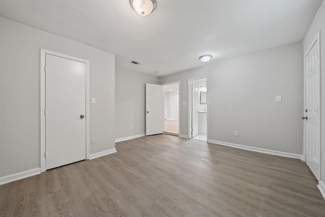 5313 Doolittle Blvd, Houston, TX 77033 - unfurnished bedroom featuring wood finished floors, baseboards, and connected bathroom