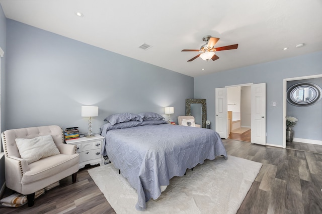 bedroom with wood finished floors, baseboards, and a ceiling fan