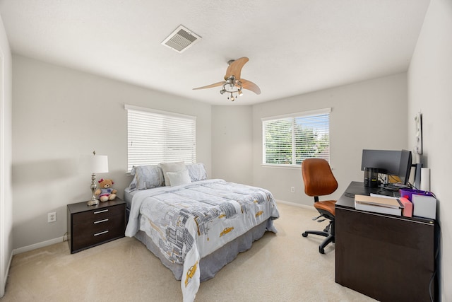 bedroom featuring light colored carpet, a desk, and baseboards