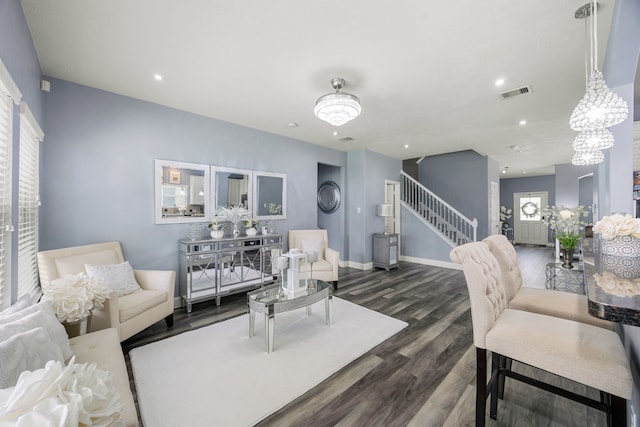 living area with wood finished floors, stairs, recessed lighting, and baseboards