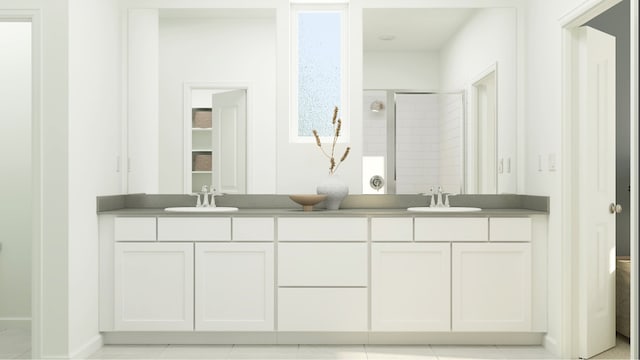 full bath featuring double vanity, a shower stall, and tile patterned floors