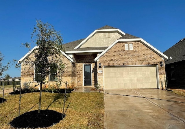 3089 Harrier Dr, Katy, TX 77493 - view of front of house with an attached garage, driveway, brick siding, a front lawn, and roof with shingles