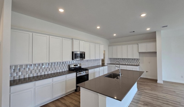 3089 Harrier Dr, Katy, TX 77493 - kitchen with appliances with stainless steel finishes, dark countertops, tasteful backsplash, white cabinetry, and recessed lighting