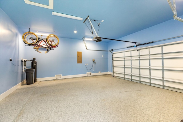 9 Caravelle Ct, Galveston, TX 77554 - garage featuring a garage door opener, electric panel, baseboards, and recessed lighting
