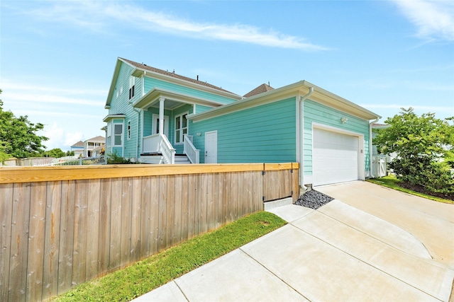 9 Caravelle Ct, Galveston, TX 77554 - view of front of house featuring a fenced front yard, a garage, and concrete driveway