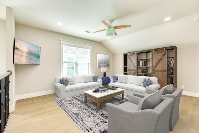 9 Caravelle Ct, Galveston, TX 77554 - living room with ceiling fan, a barn door, recessed lighting, light wood-style flooring, and baseboards