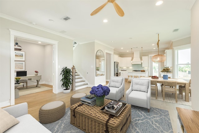 9 Caravelle Ct, Galveston, TX 77554 - living area with light wood finished floors, stairway, ornamental molding, recessed lighting, and baseboards