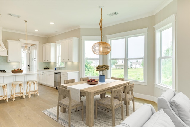 9 Caravelle Ct, Galveston, TX 77554 - dining room with light wood-style flooring, ornamental molding, recessed lighting, and baseboards