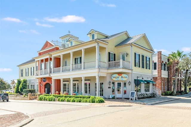9 Caravelle Ct, Galveston, TX 77554 - view of front facade with a balcony and a porch