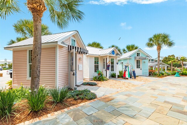 9 Caravelle Ct, Galveston, TX 77554 - view of front of house featuring metal roof and a standing seam roof