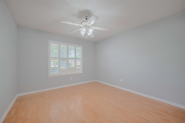 22010 Elsinore Dr, Katy, TX 77450 - unfurnished room featuring light wood-style floors, a textured ceiling, baseboards, and a ceiling fan