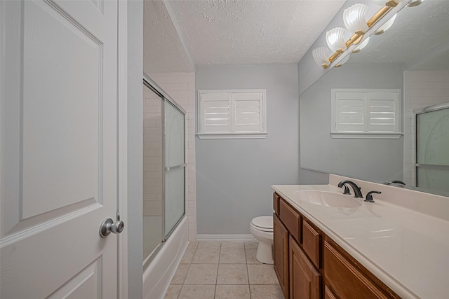 22010 Elsinore Dr, Katy, TX 77450 - full bathroom with vanity, toilet, baseboards, a textured ceiling, and tile patterned floors