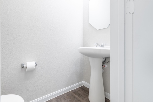 24511 Lorenzo Glaze Trl, Katy, TX 77493 - half bath with wood finished floors, baseboards, toilet, and a sink